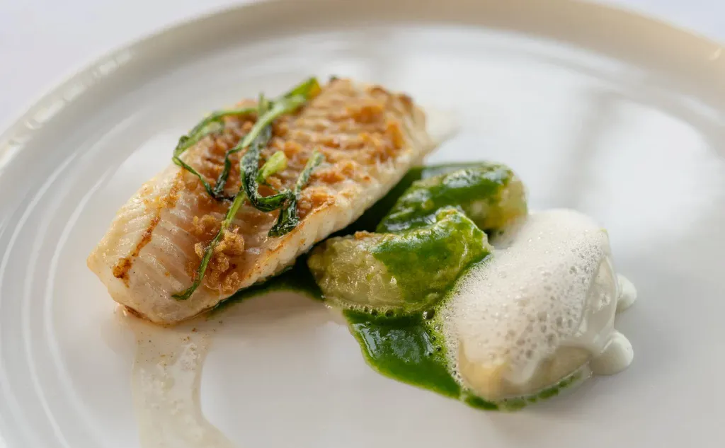 Alléno au Pavillon Ledoyen - Sole cooked meuinere style with crispy chicken skin, puntarella, and Parmigiano cheese.
