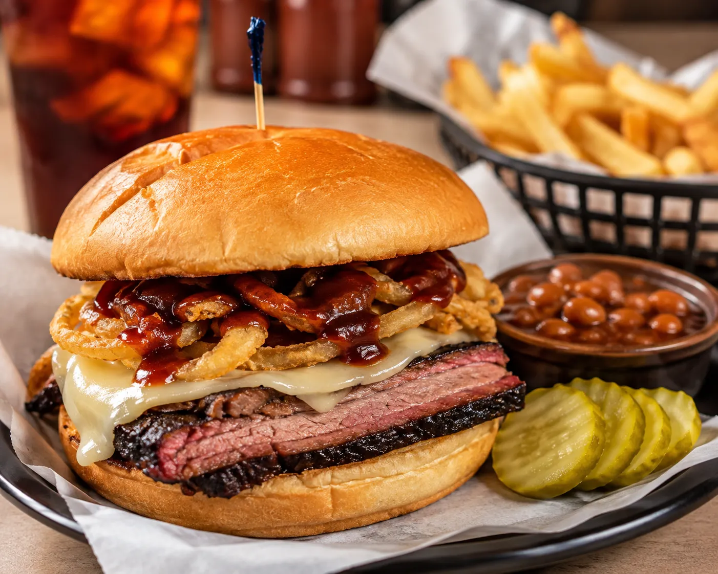 A Kansas City staple, this savory sandwich stacks tender brisket, smoked provolone, and crispy onion rings on a Kaiser bun