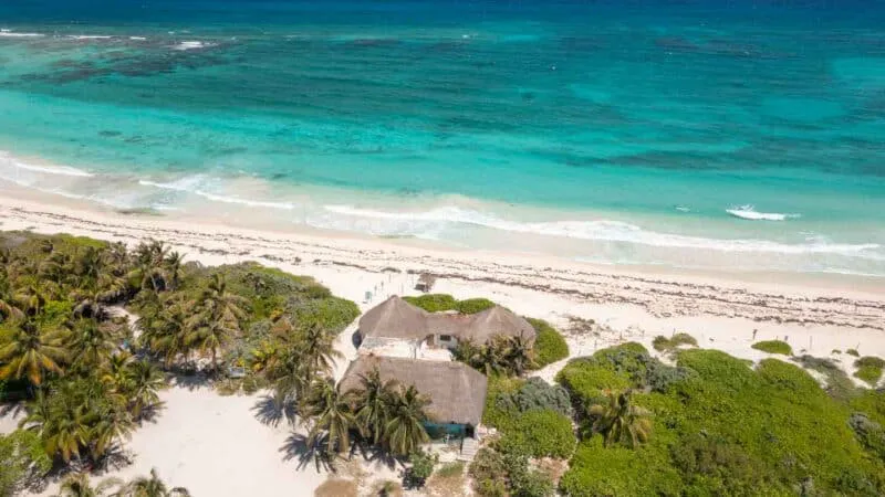 Xcacel Beach Aerial photo of Xcacel Beach, showing its stunning clear-waters, white sand and the flora and fauna.